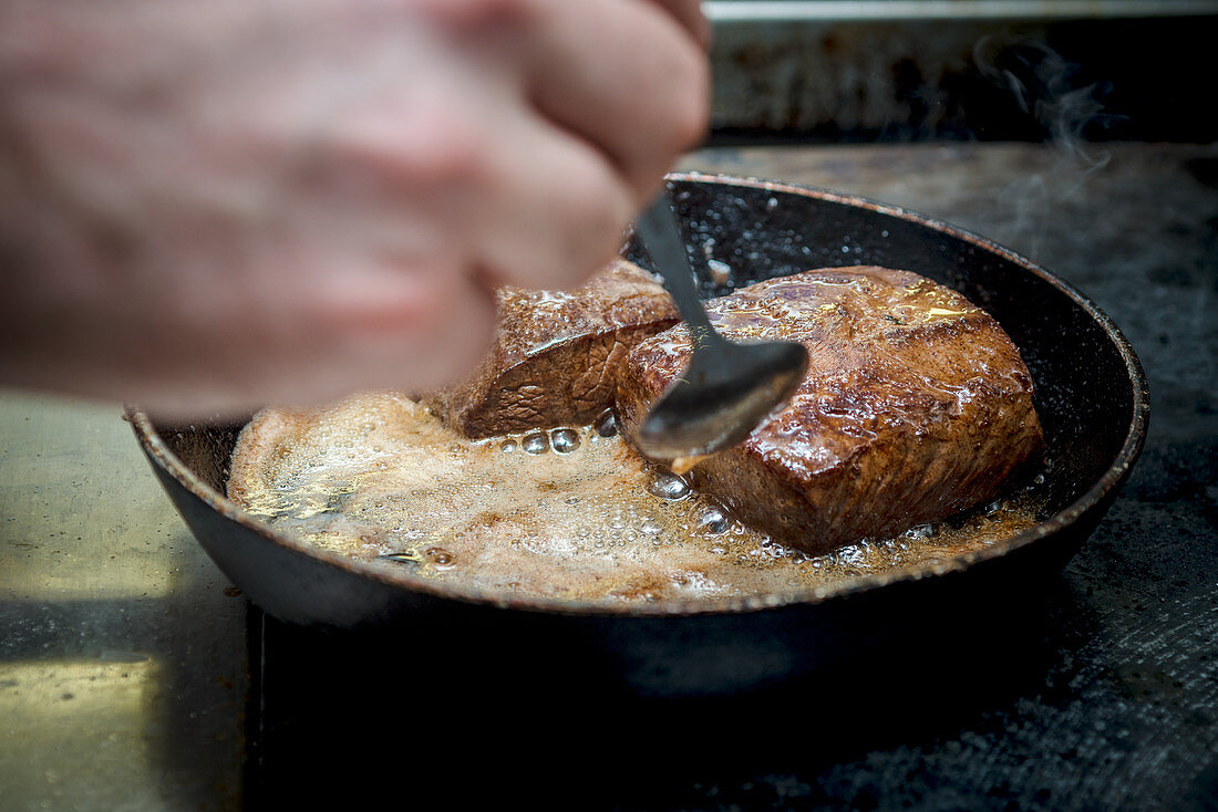 Frying meat in a pan