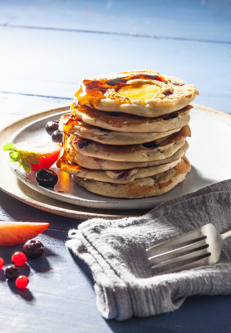 Pancakes with red fruit and banana