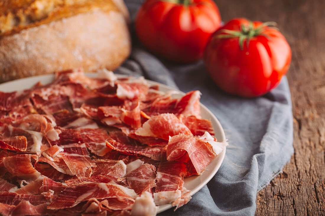 Typical spanish ham with tomatoes and bread, ready to prepare pantumaca