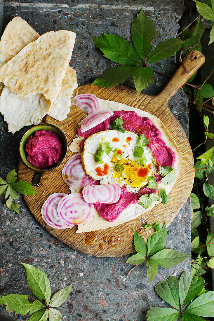 Beetroot hummus with fried egg and radicchio on flatbread