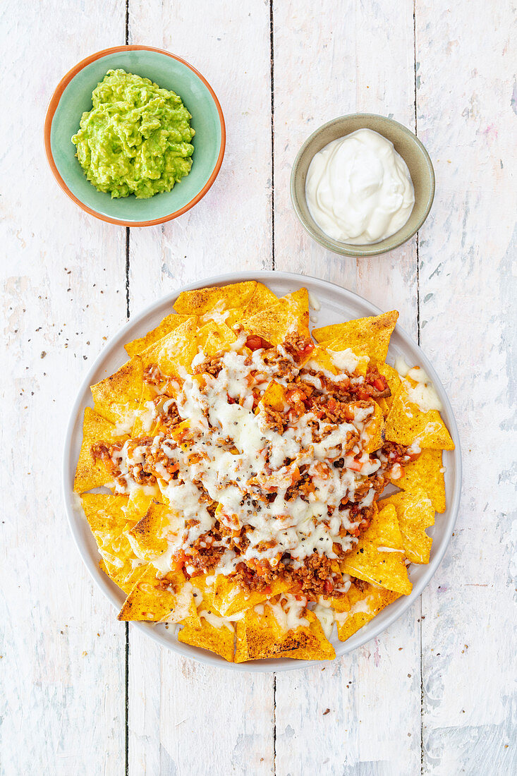 Nachos with minced meat, guacamole and sour cream (Mexico)