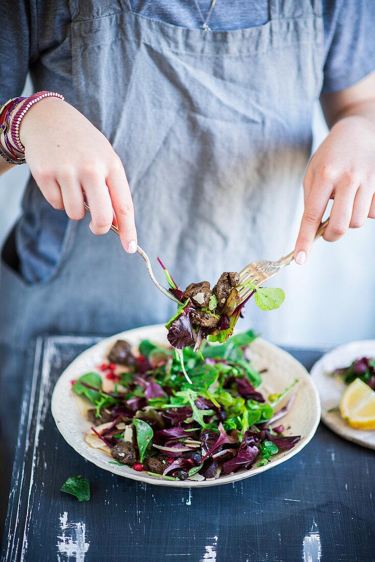 Tossing a chicken liver salad