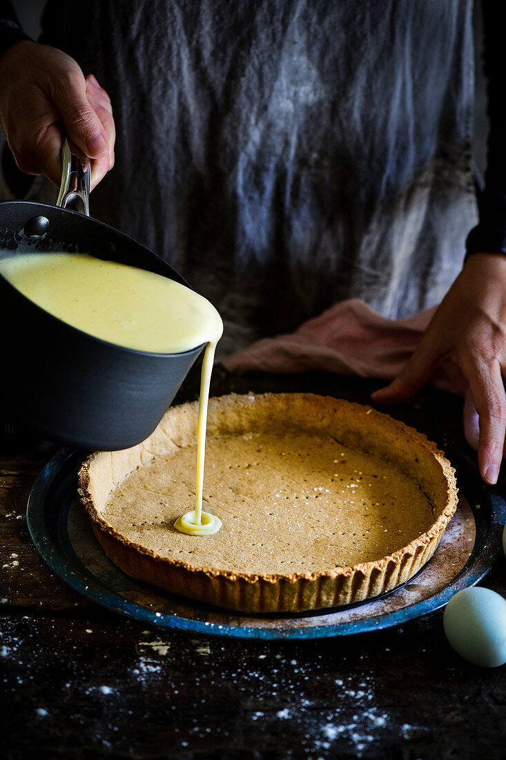 Pouring the filling into the flan case