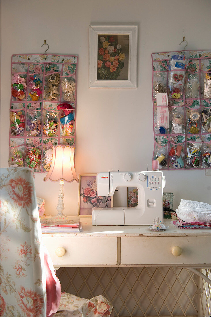 Sewing machine in romantic crafting area with organisers on wall