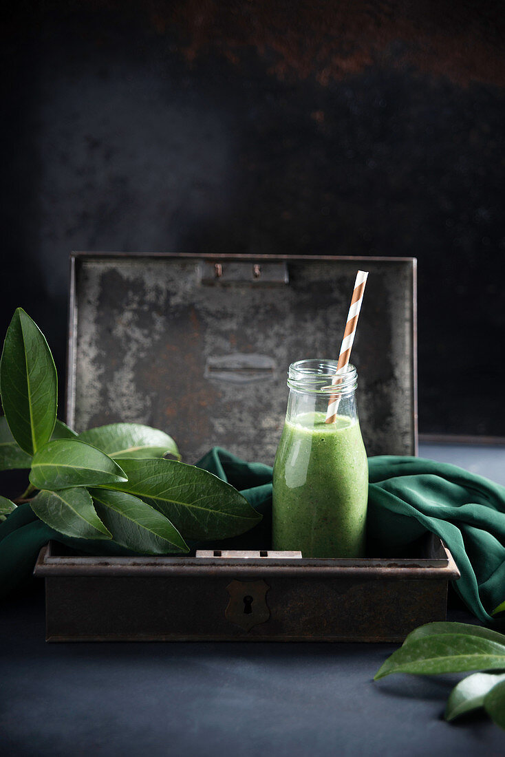 Vegan green smoothie with bananas, peaches, broccoli and spinach