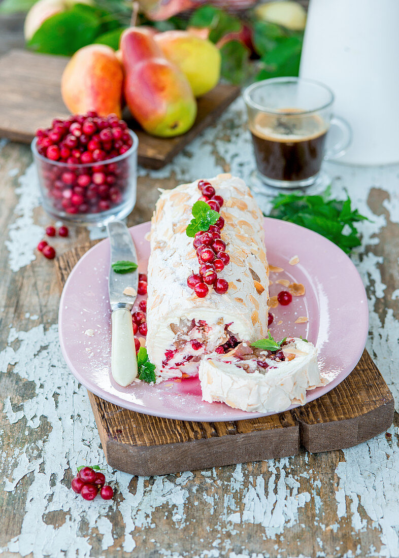 Cranberry and alomnd meringue roll with pears and cream