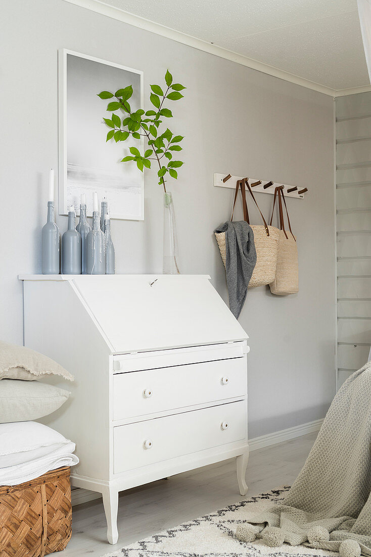 White-painted bureau in pale bedroom