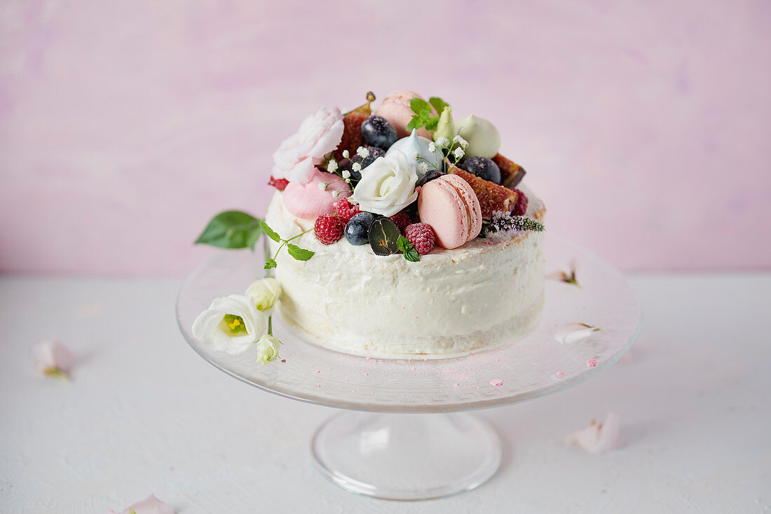 Festive cake decorated with macarons and berries