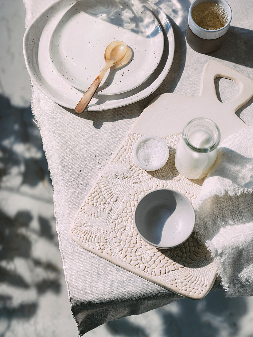 Ceramic dishes, salt and milk on a table