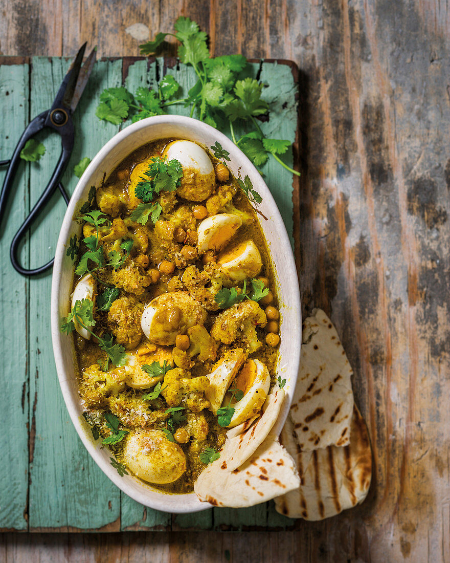 Indian cauliflower curry with boiled eggs and coconut dust