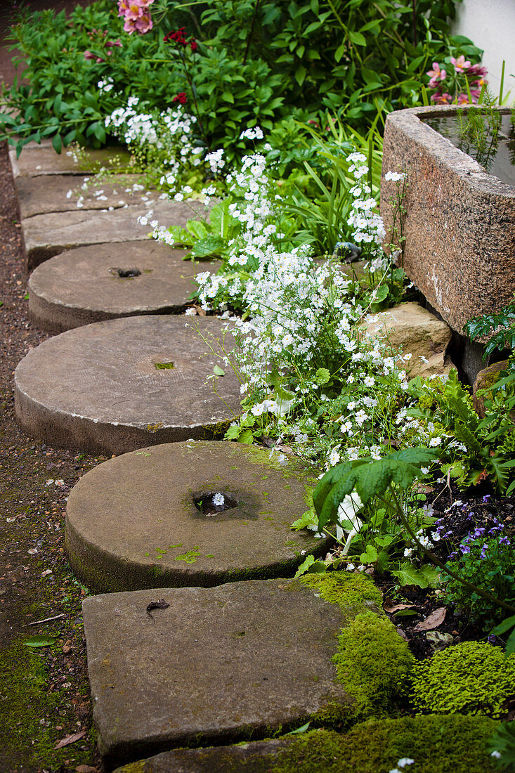 Garden path made from old millstones and sandstone slabs