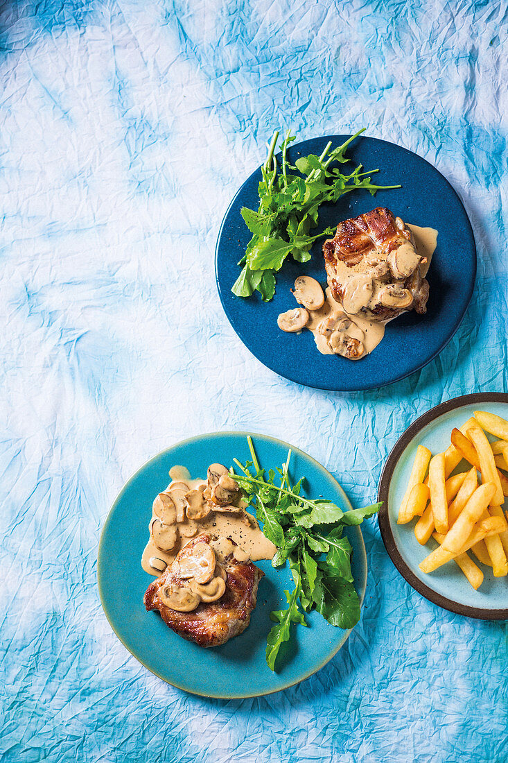 Pork neck steaks with miso mushroom sauce and chips