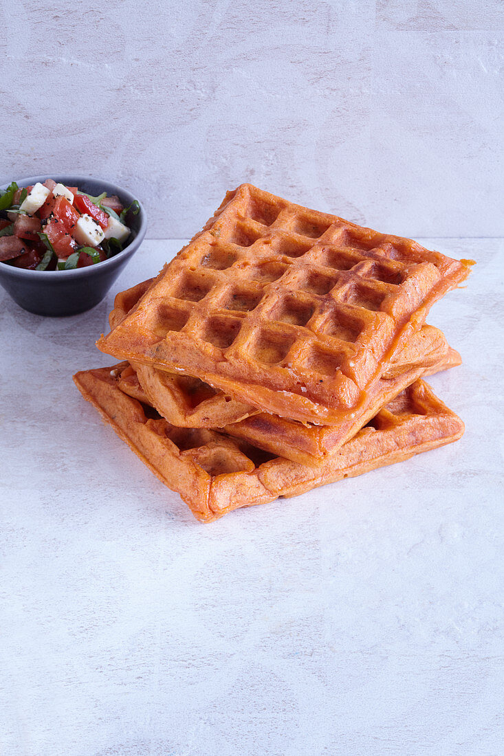 Pizza waffles with tomato salad