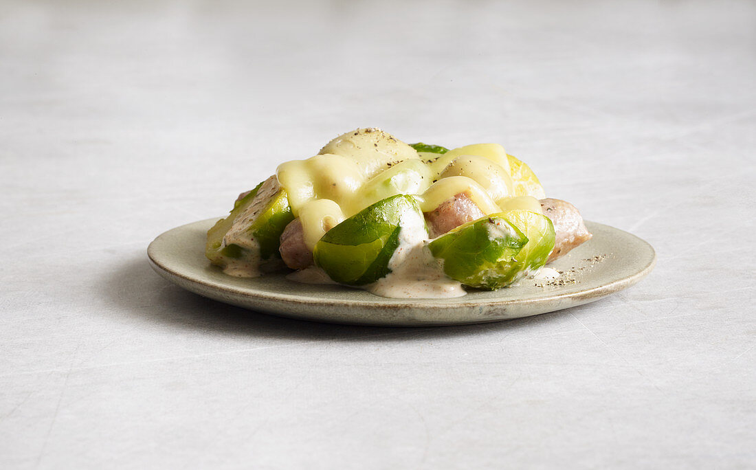 Brussels sprouts and sausage mix with Appenzeller cheese made in a raclette