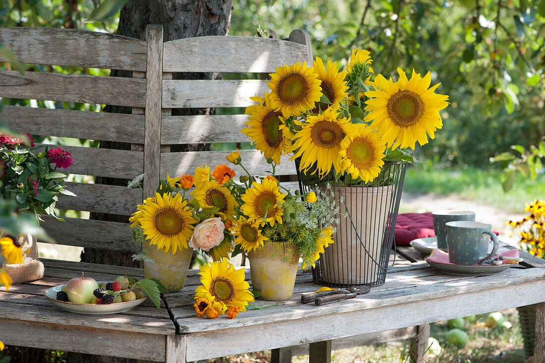 Bouquets With Sunflowers, Rose Blossom And Marigolds On Tree Bench