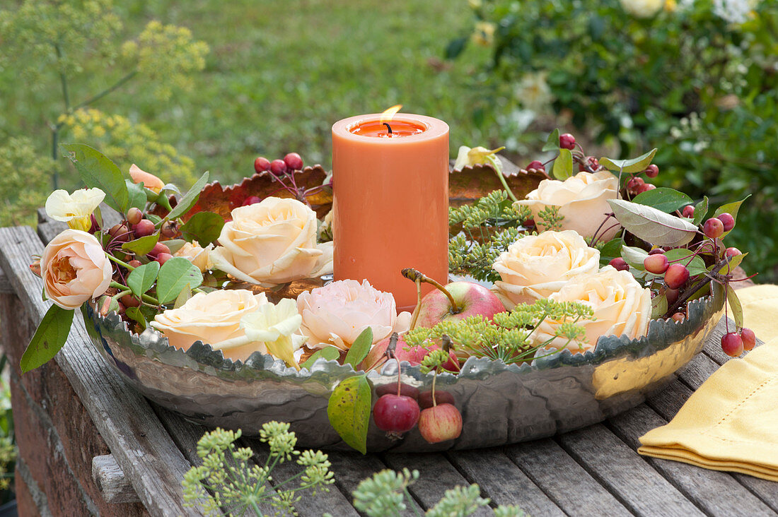 Rose Petals And Ornamental Apples With Candle In Silver Bowl