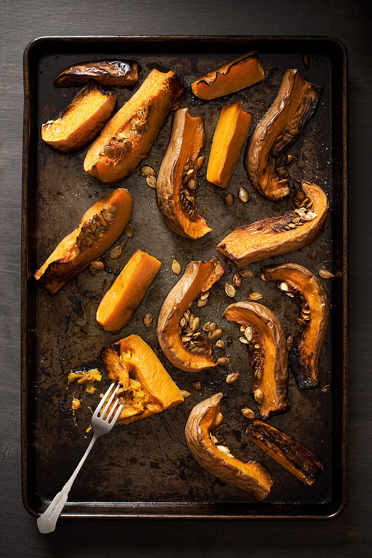 Butternut squash roasted with olive oil and sea salt on a roasting tray
