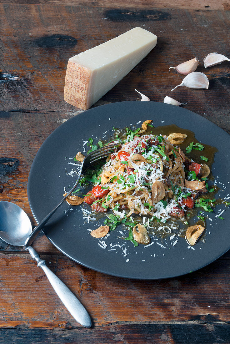 Pasta dish with mushrooms tomatoes and Parmesan cheese