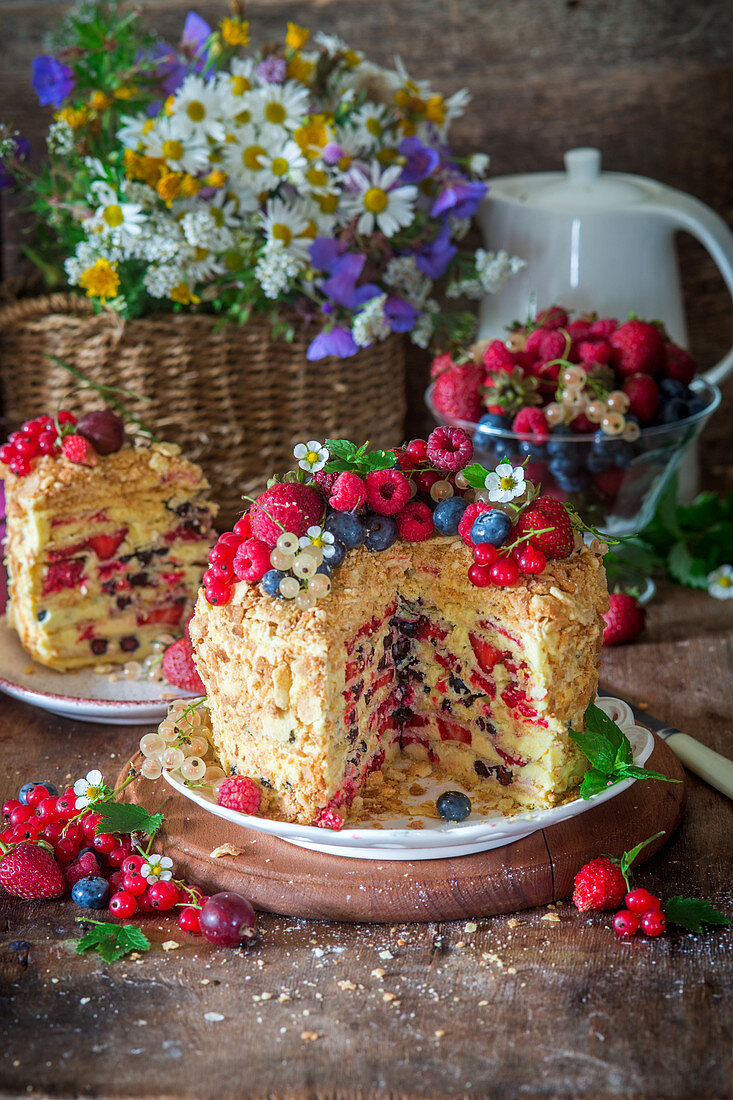 A summer Napoleon cake with berries, sliced