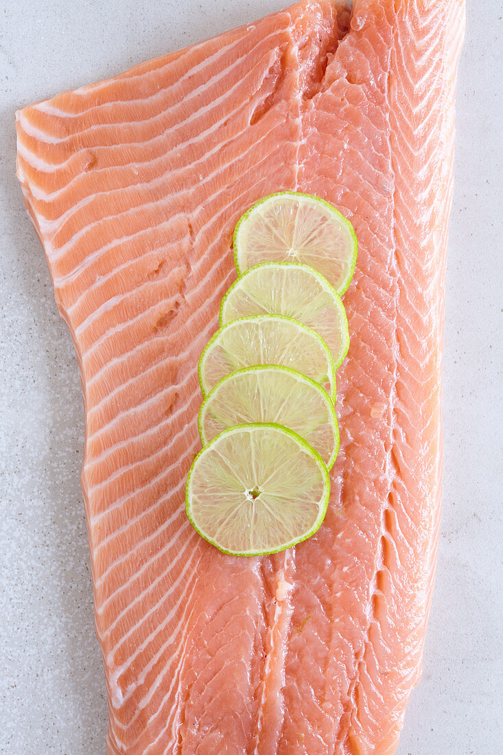 A side of fresh salmon with lemon slices