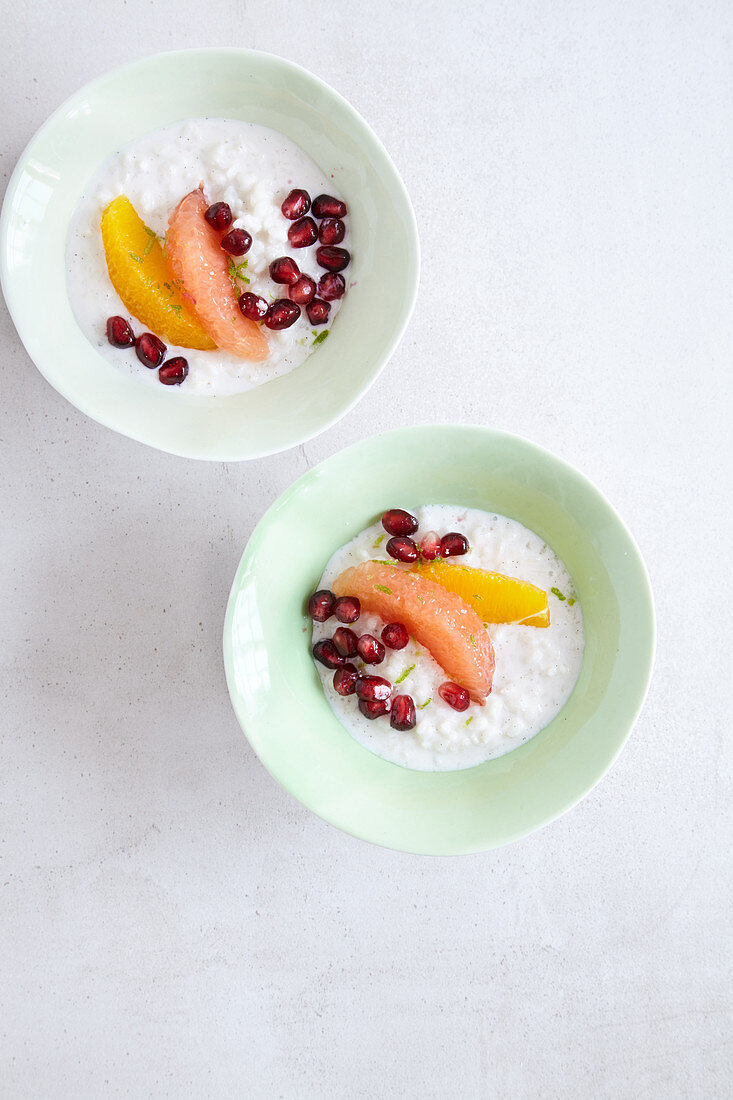 Almond milk rice pudding with citrus fruit made in a tagine