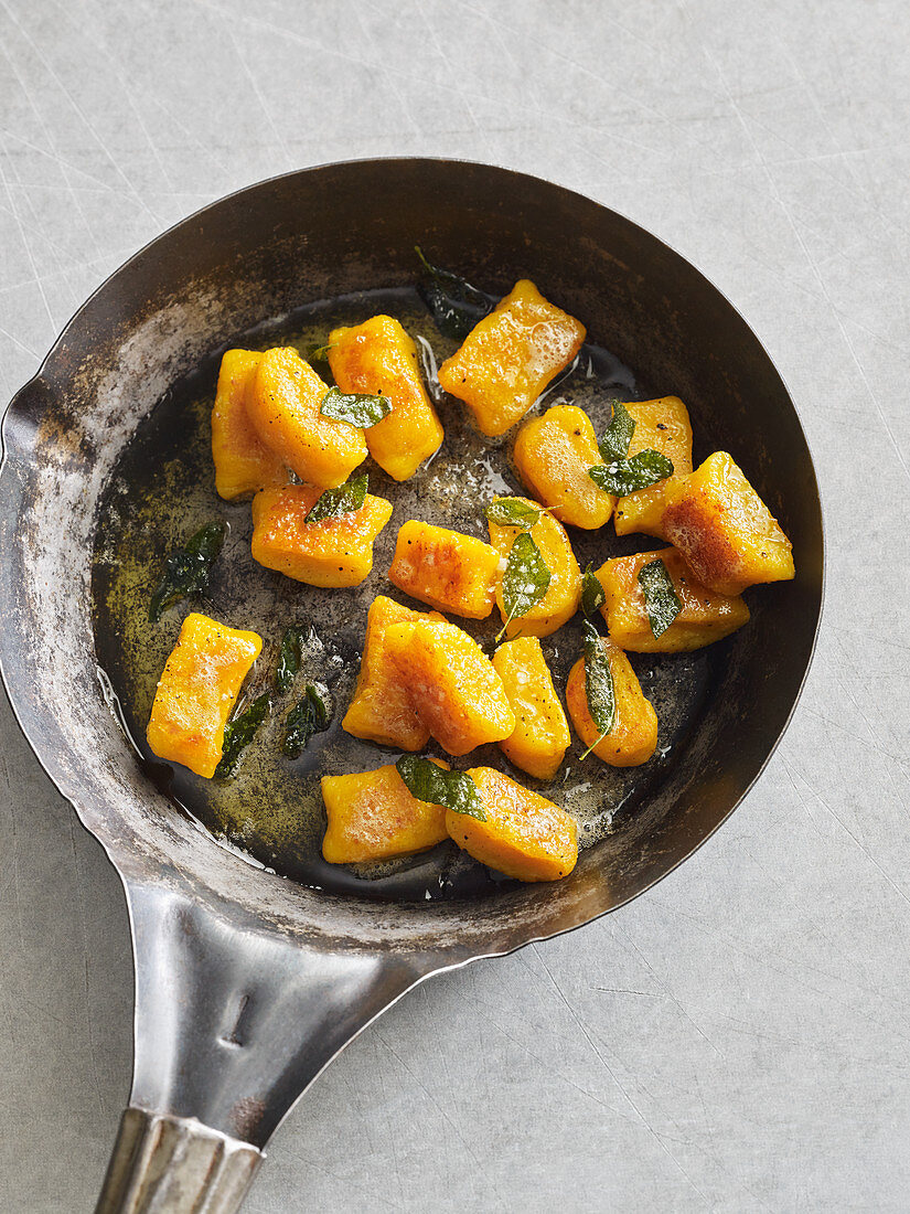 Pumpkin gnocchi with sage butter in a pan