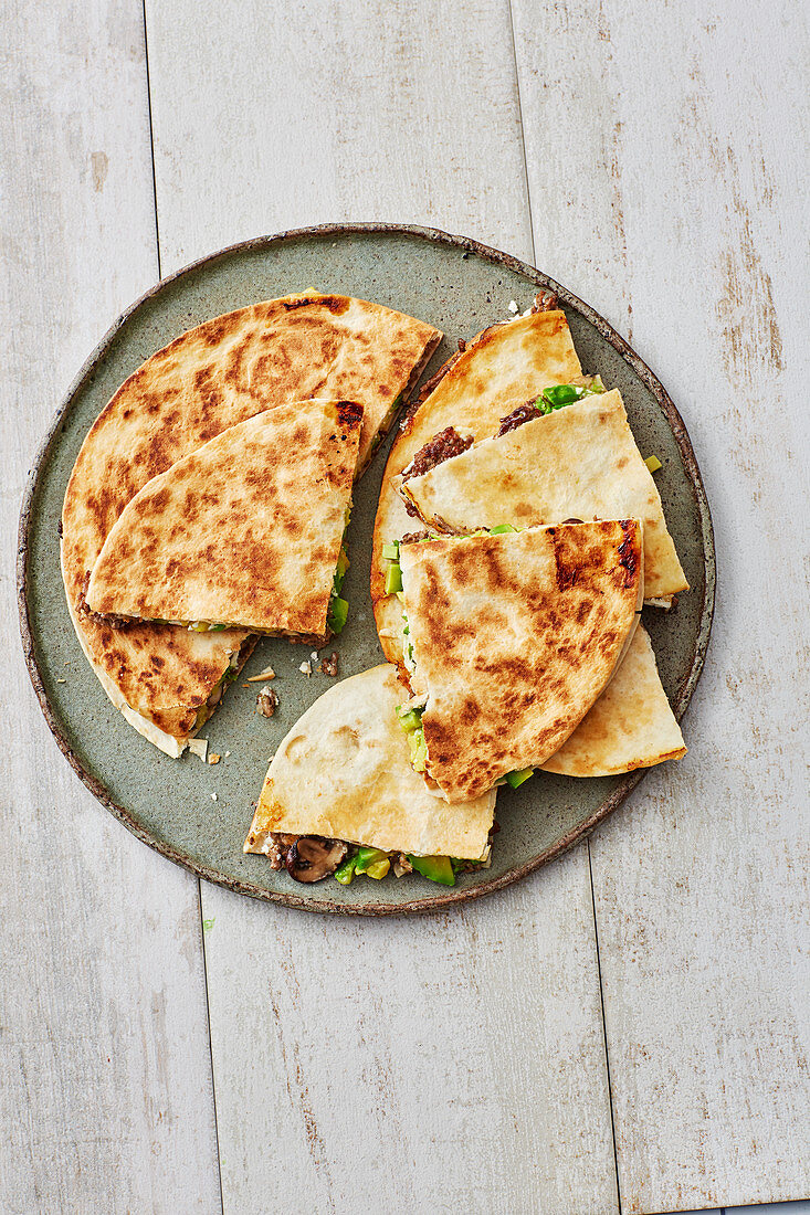 Mexican avocado quesadillas with minced beef and mushrooms