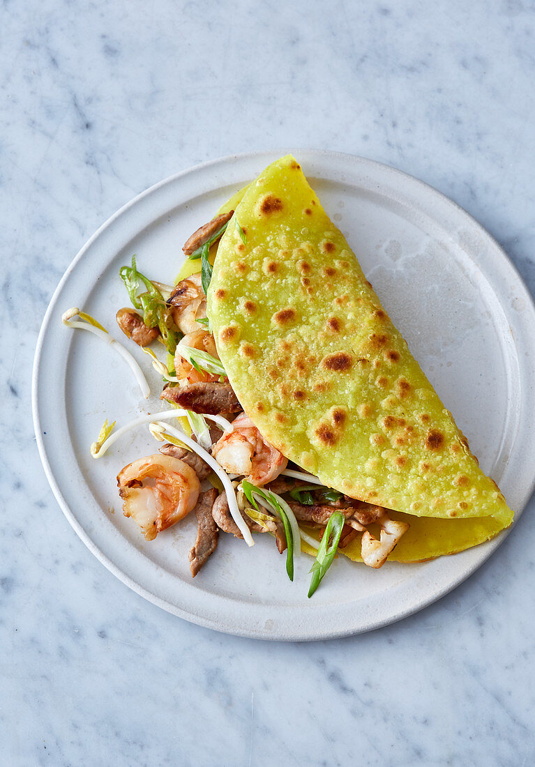 Vietnamese stuffed rice flour and coconut crepes with prawns