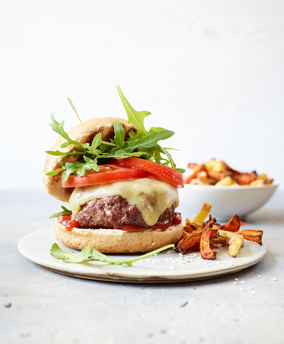 A cheeseburger with veggies fries made in a hot-air fryer