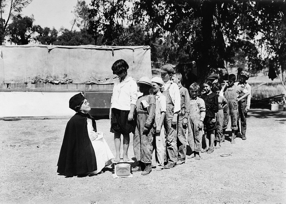 Children being weighed at tuberculosis camp, 1920