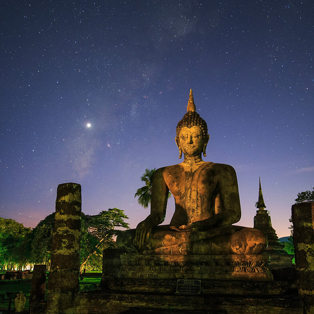 Night sky over Buddha statue, Thailand