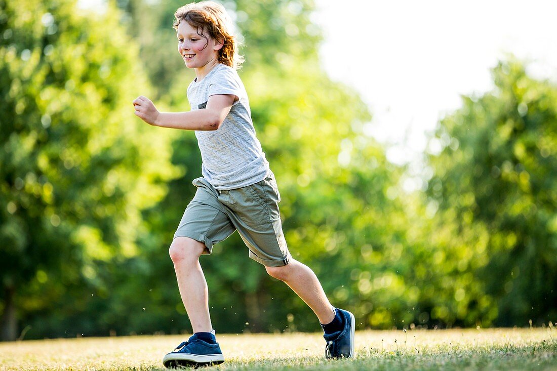 Boy running in park