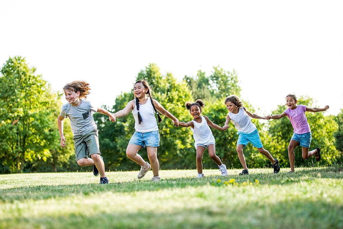 Children holding hands and running