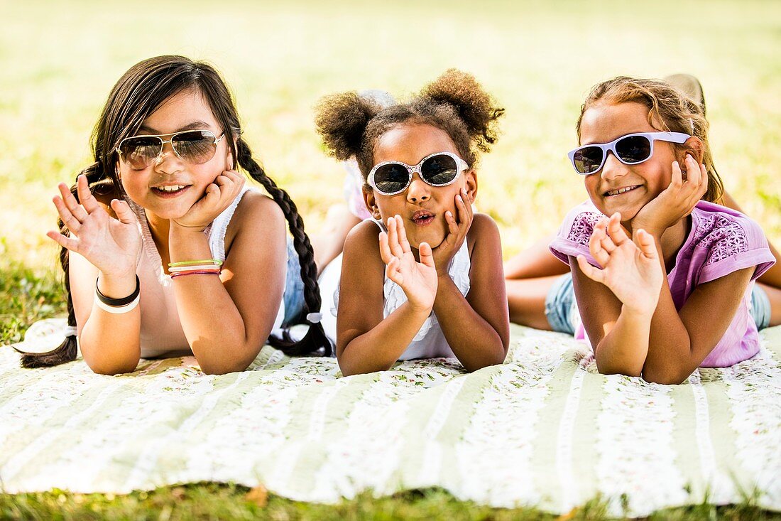 Girls lying on blanket in park