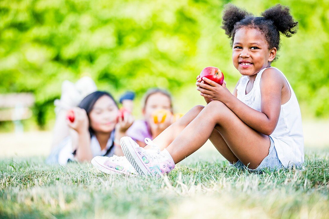 Girls holding various fruits