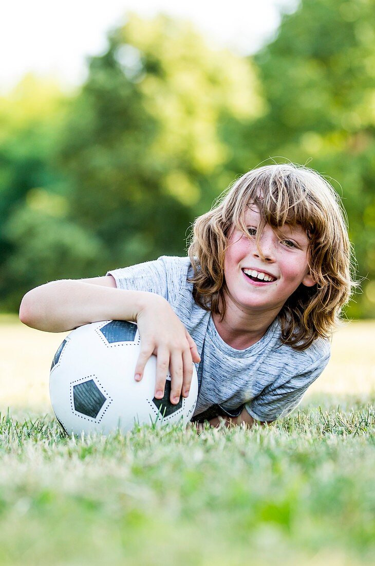 Boy playing with football