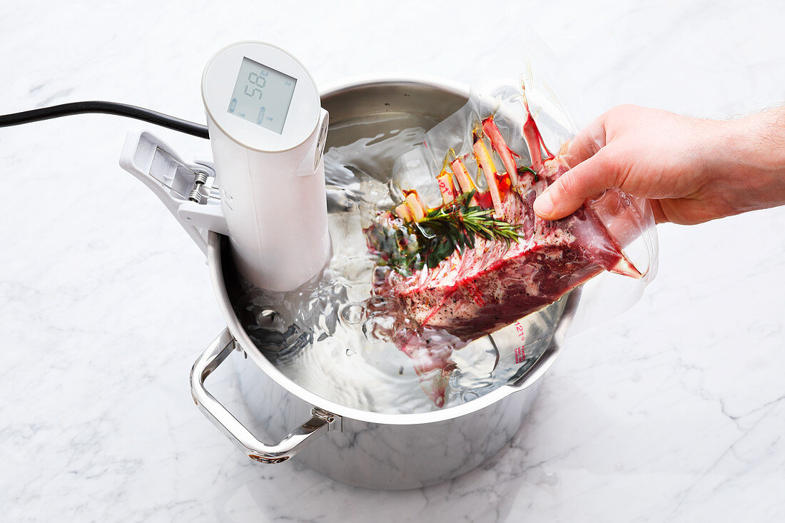 Saddle of lamb being cooked with a sous vide stick