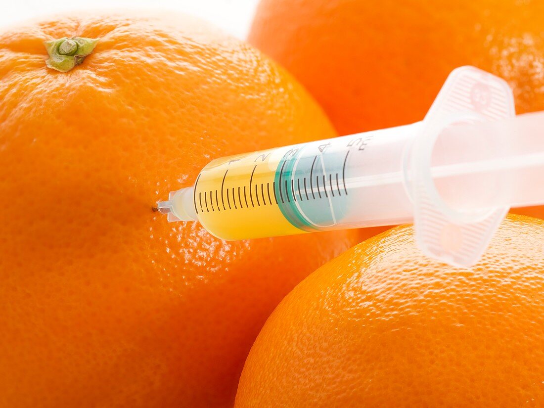 Oranges with syringe