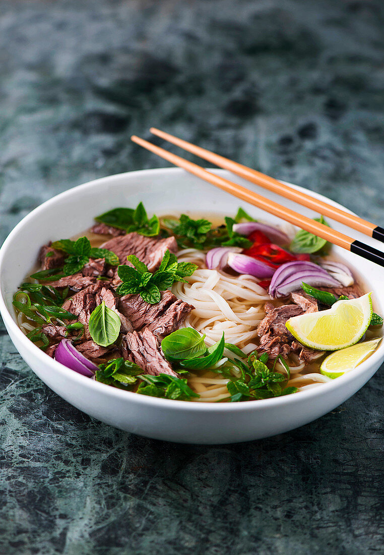 Pho bo (traditional beef soup with rice noodles, Vietnam)