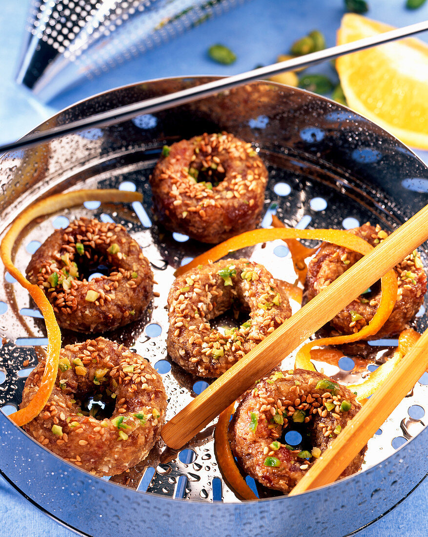 Steamed date rings with pistachio nuts and sesame seeds