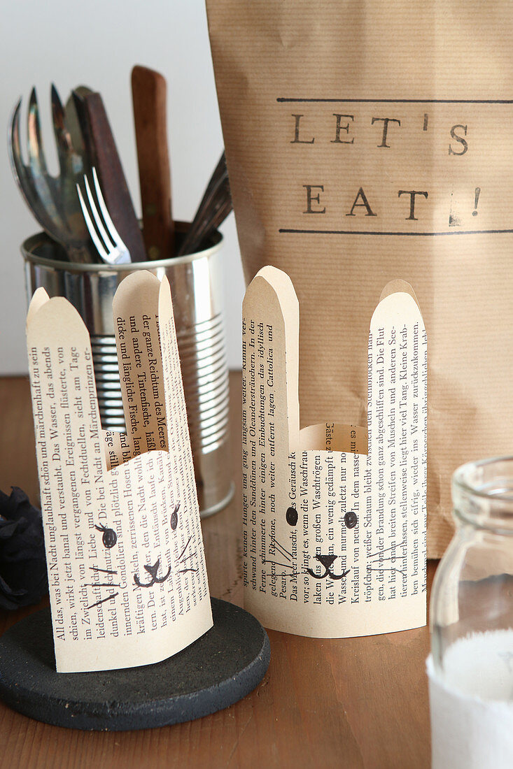 Egg cups with bunny faces hand-made from old book pages