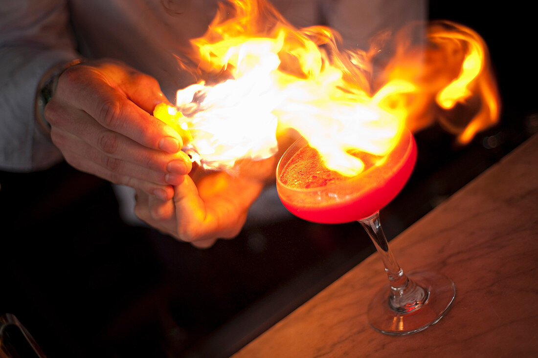 Flaming a cocktail with citrus fruit