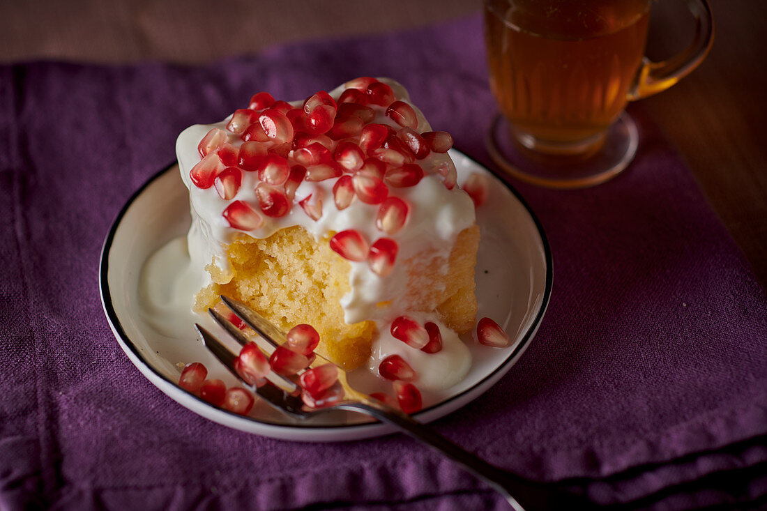 Lemon cake with cream cheese and pomegranate seeds