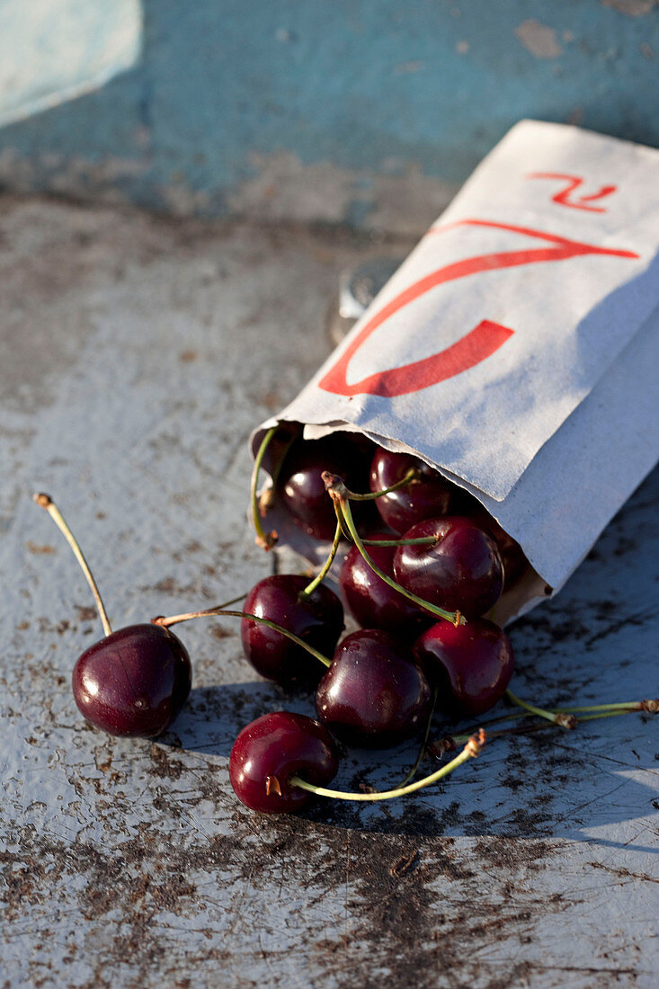 Cherries cascading out of a bag
