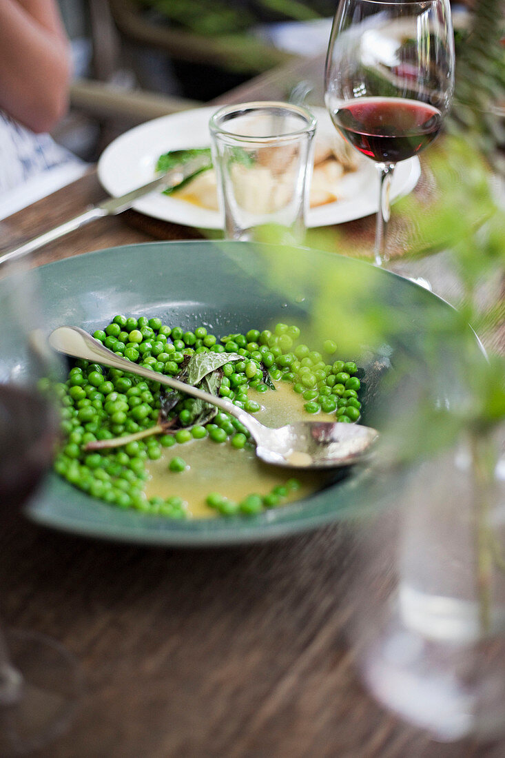 Garden peas in a bowl out on a table