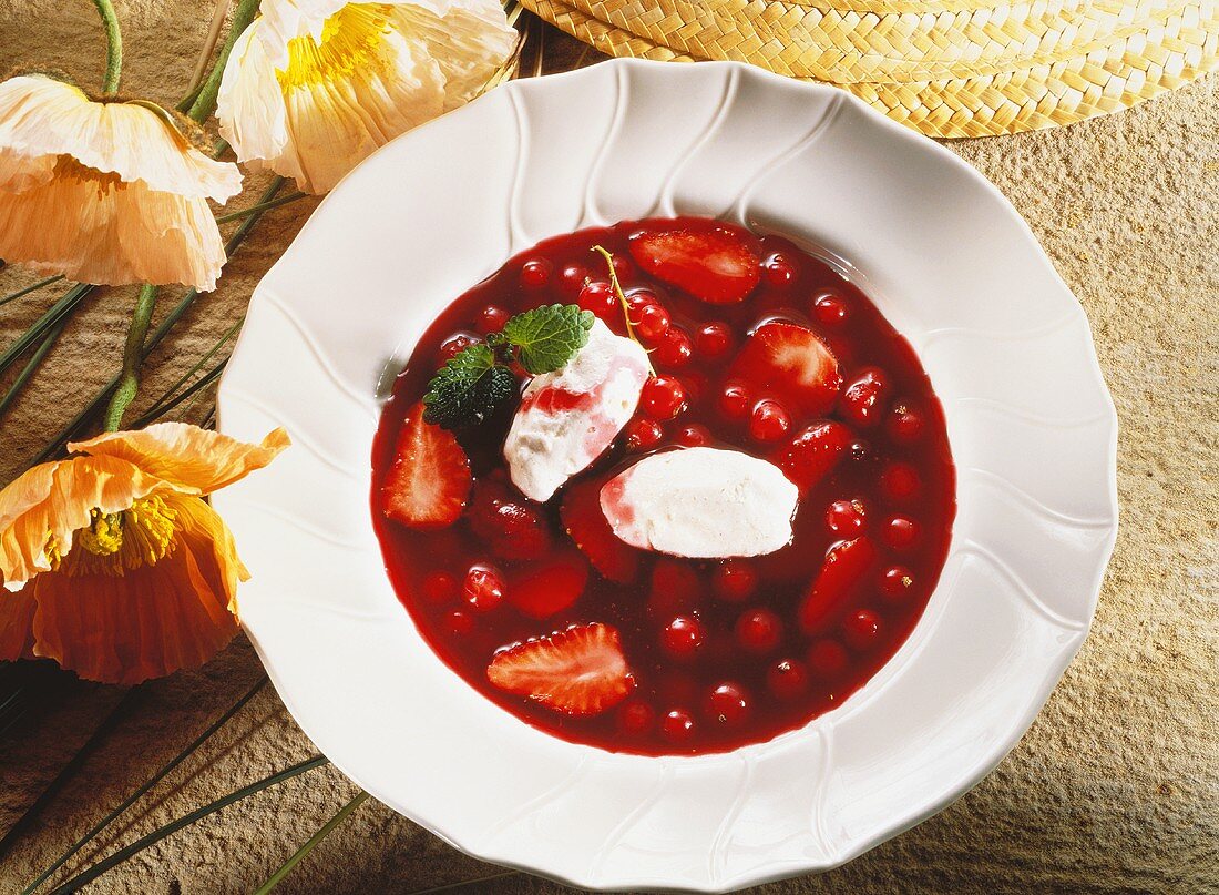 Cold soup with berries and cinnamon cream dumplings