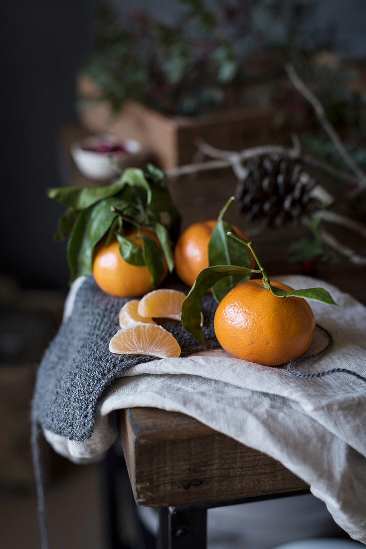 Small Mandarin oranges with branches on a table
