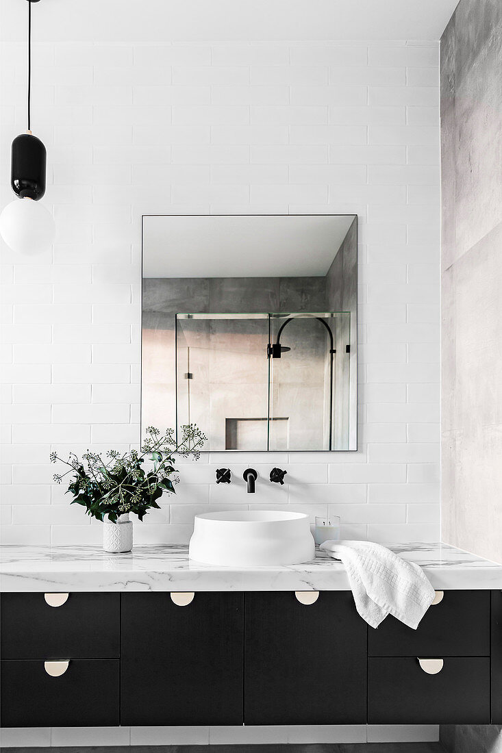 Countertop basin on vanity with marble top and drawers