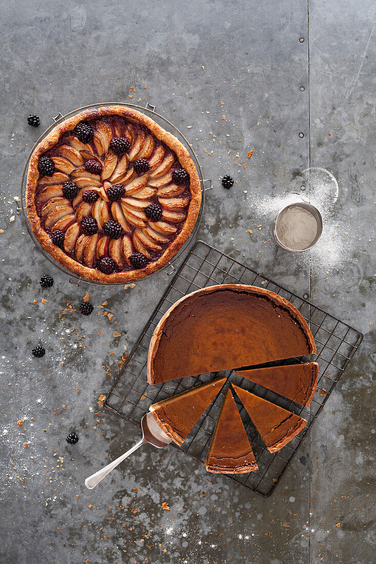 Sliced chocolate tort and apple and blackberry tart shot from above