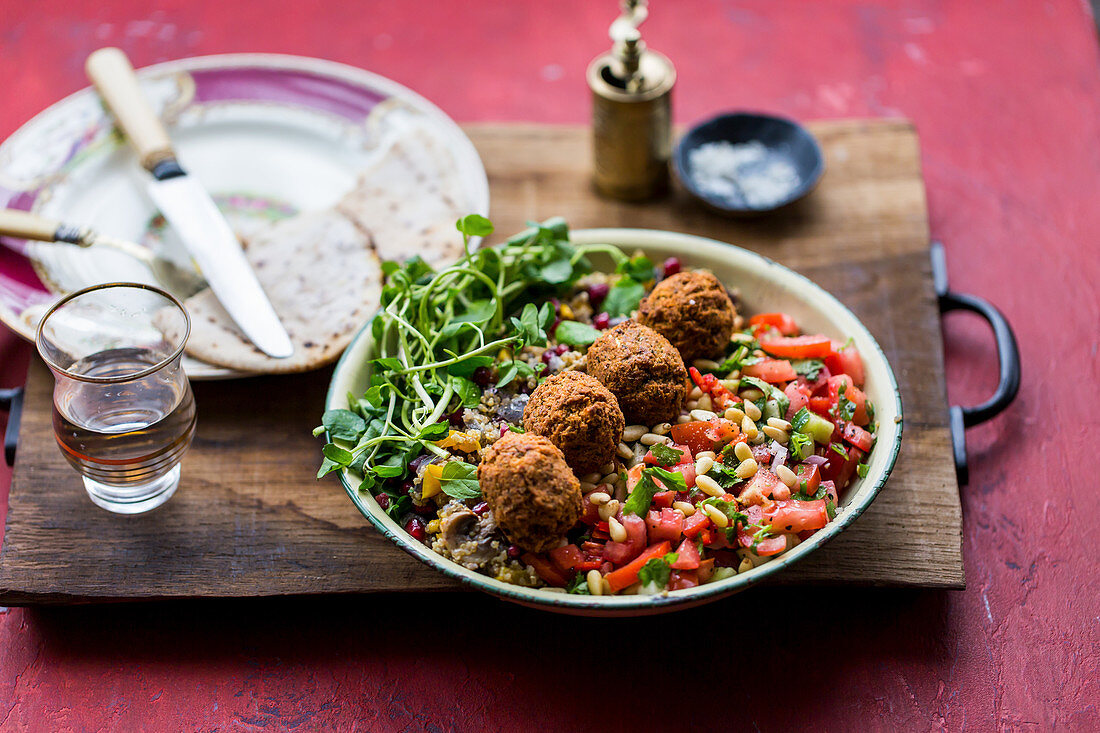 Quinoa, buddah bowl with coriander, falafel, mint, pinenuts and watercress